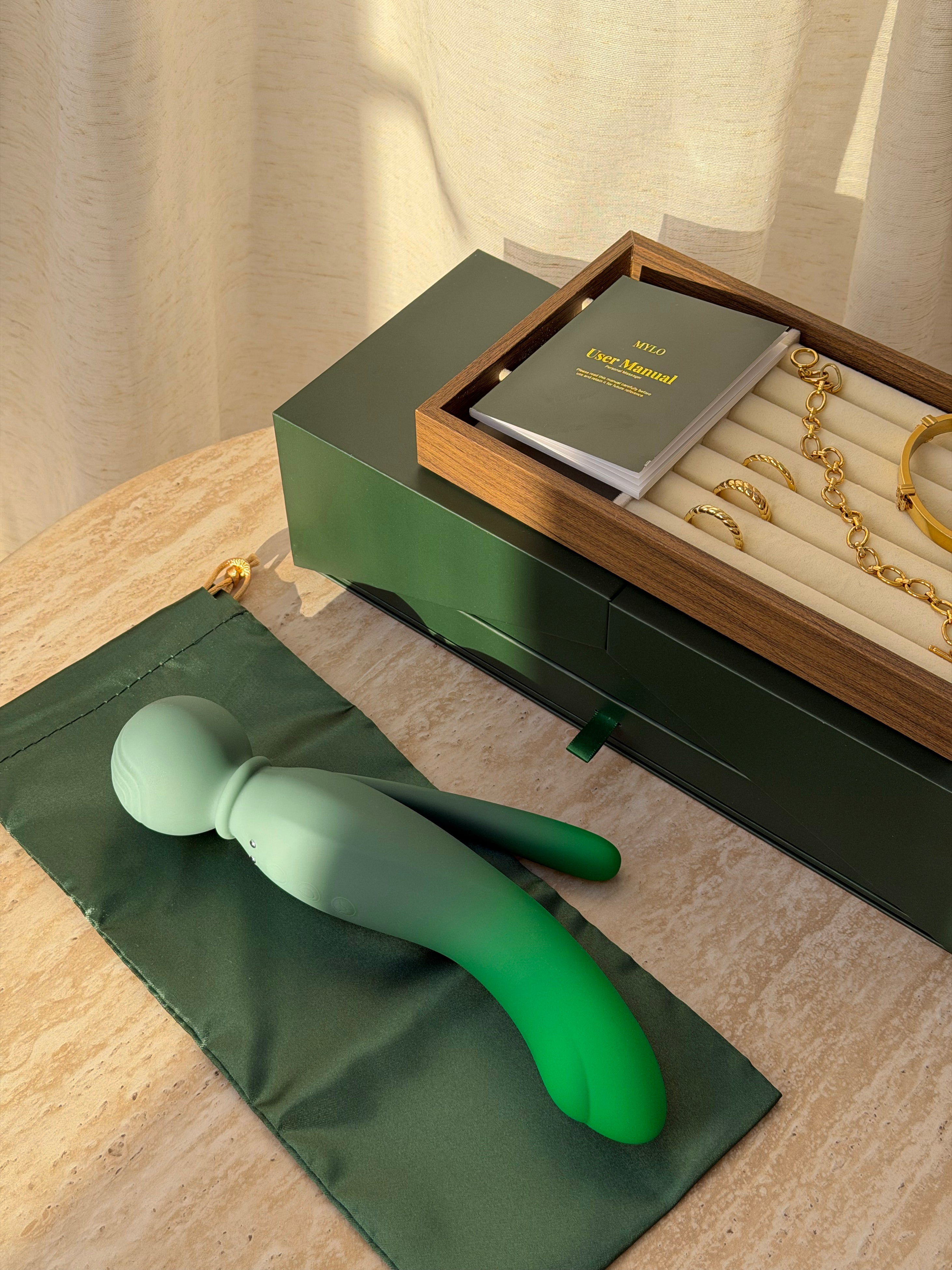 A sleek, matte-finish silicone vibrator with a smooth gradient from light sage green to vibrant emerald green.