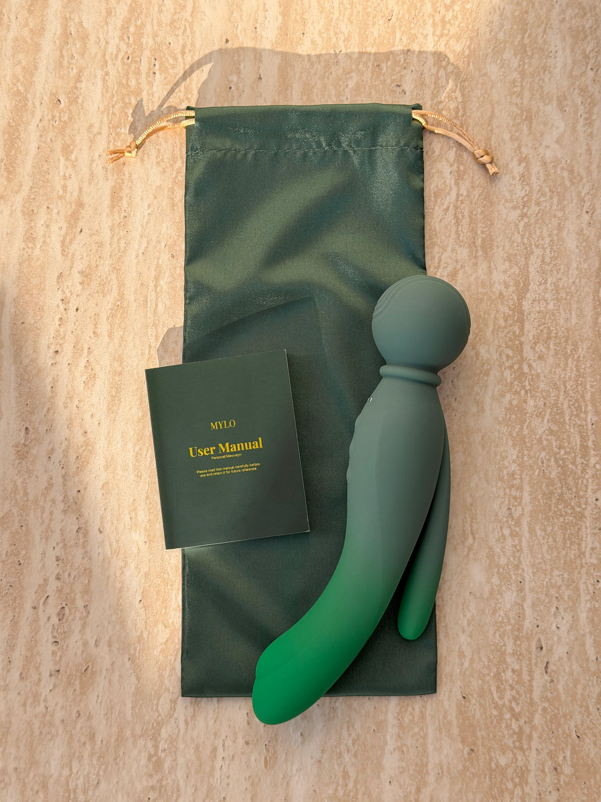 A sleek, matte-finish green mylo pleasure device with a smooth, ergonomic design and rounded head.