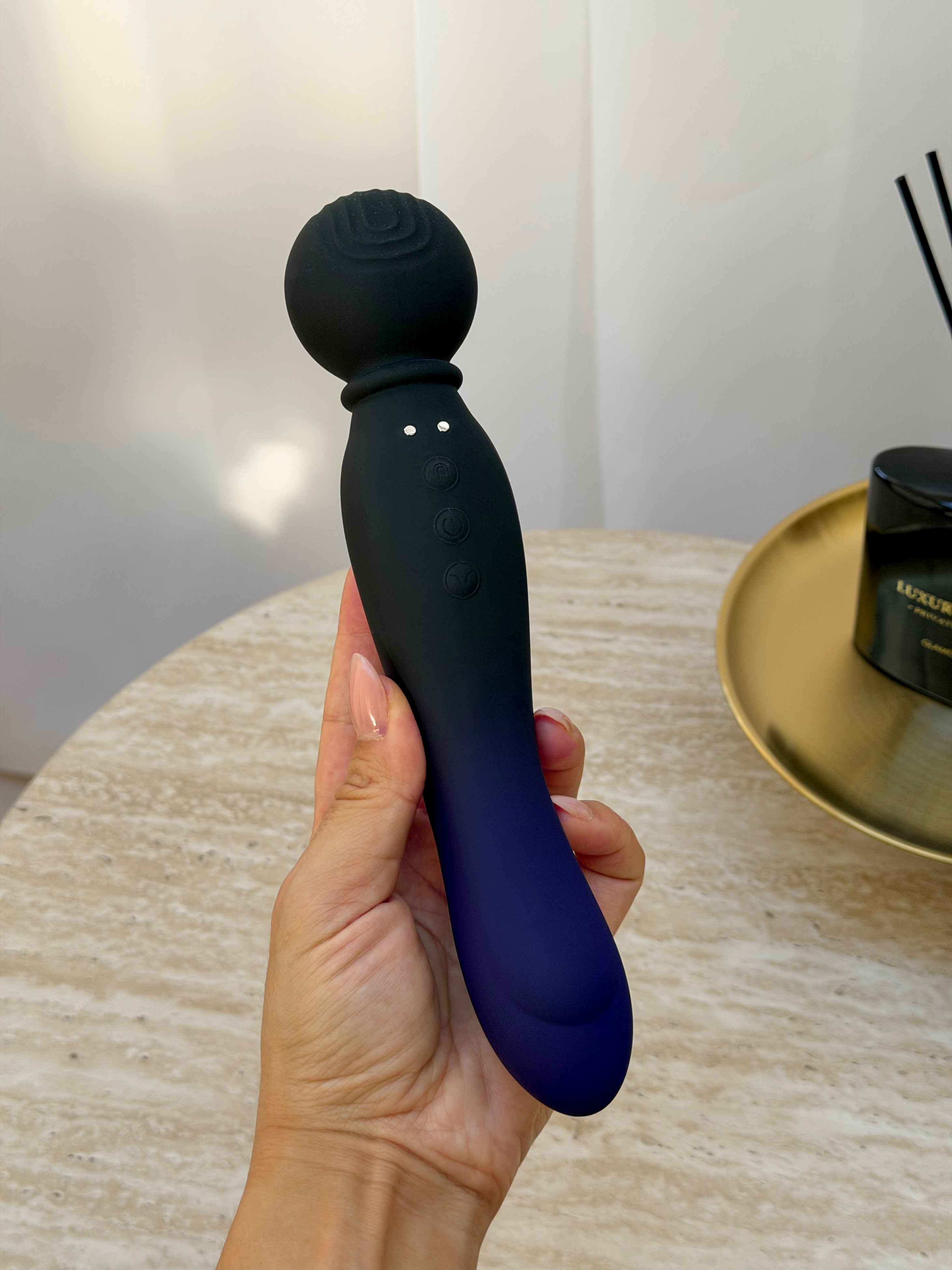 Black and navy blue silicone wand with textured spherical head and control buttons
