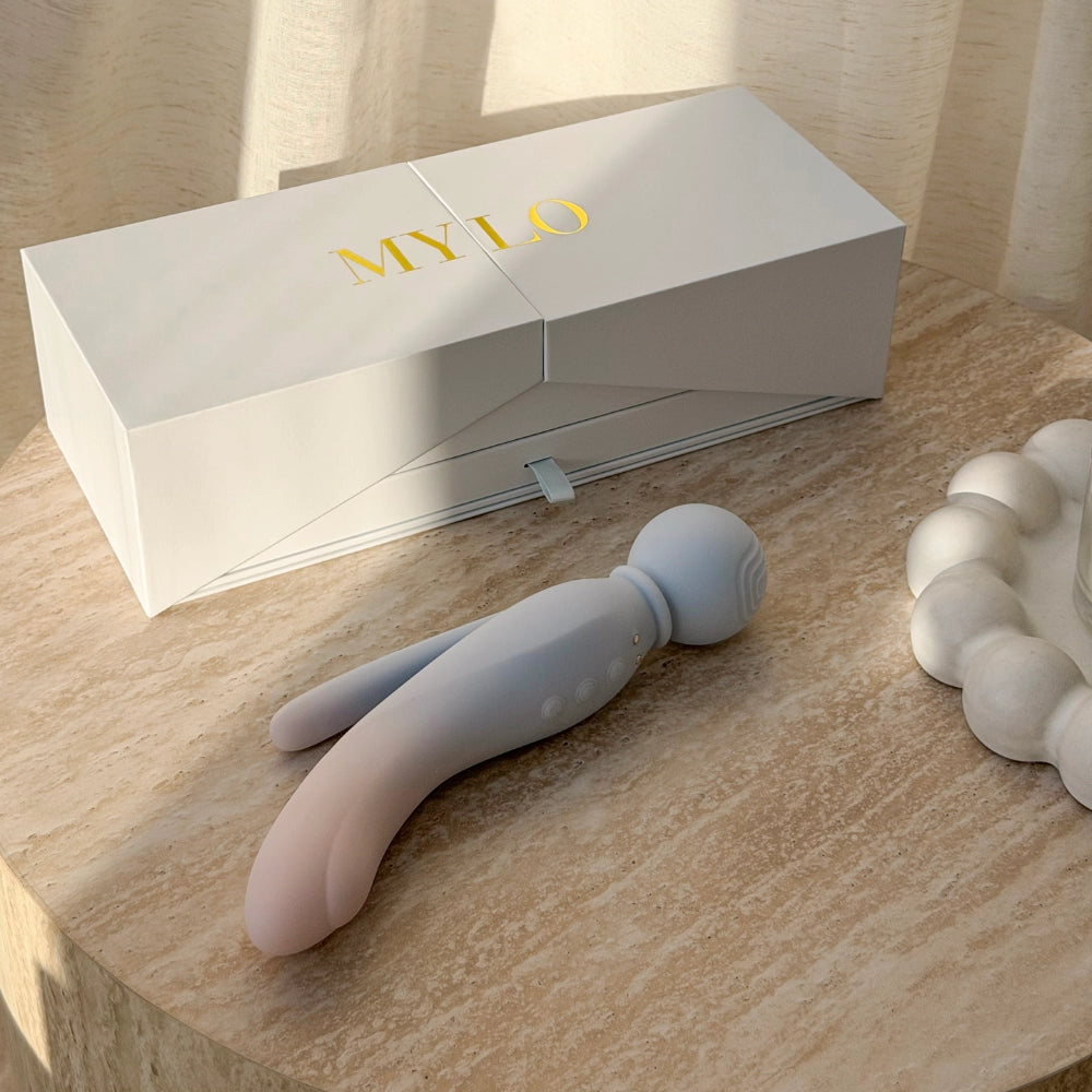 A sleek, two-toned mylo vibratory wand with a gradient from soft pink to pale blue silicone body and rounded head.